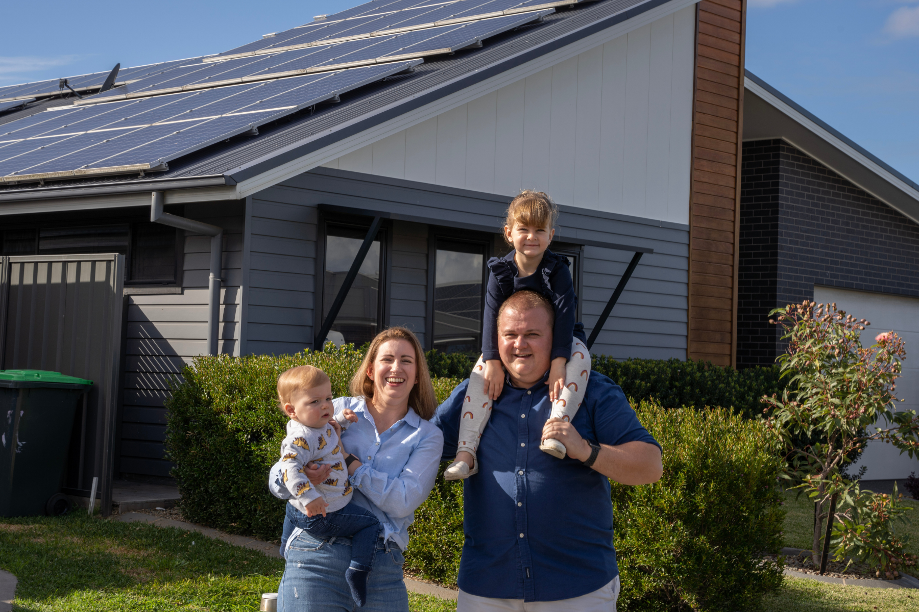 Family in front of house with solar PV